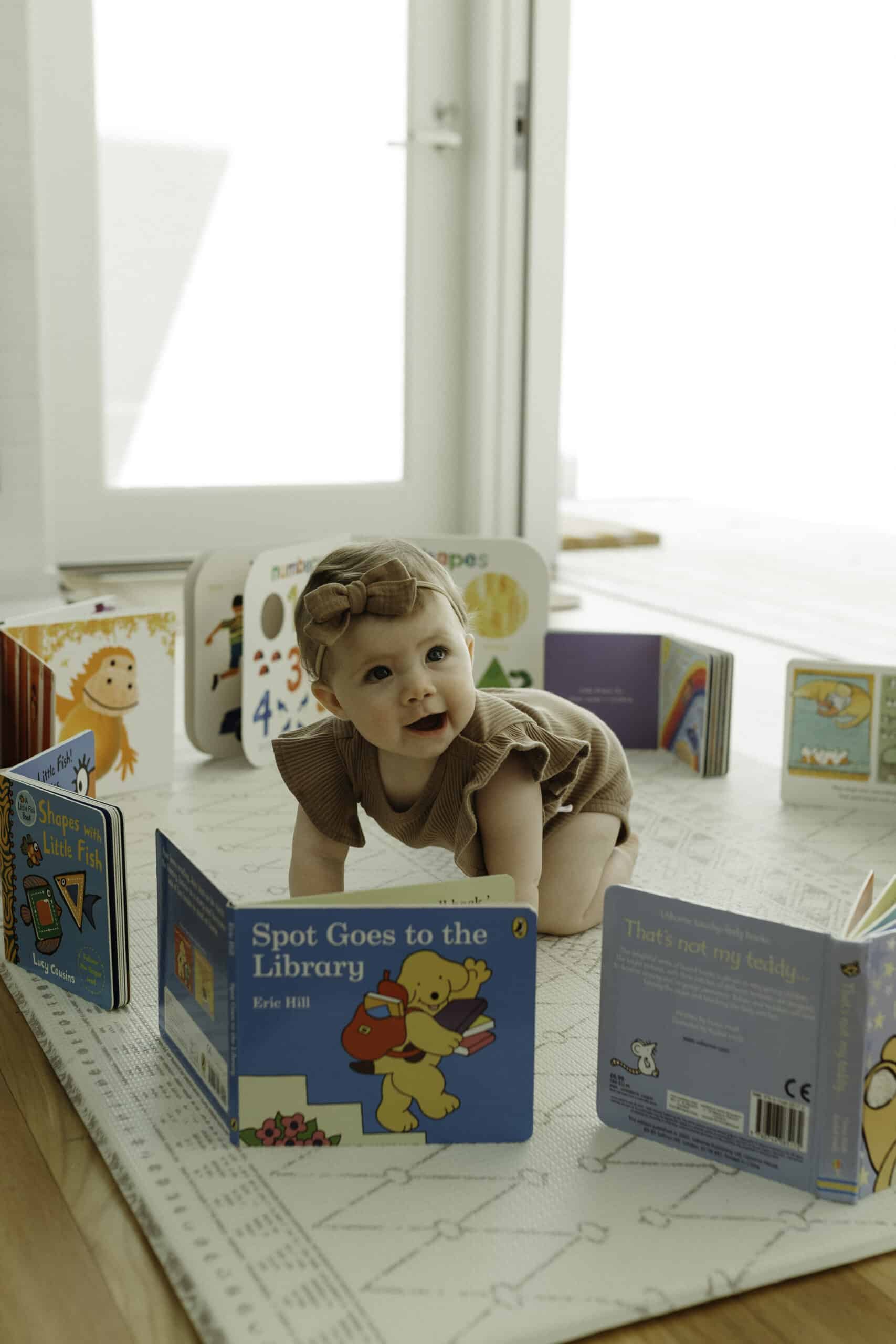 Preroller185 Baby learning how to crawl with books
